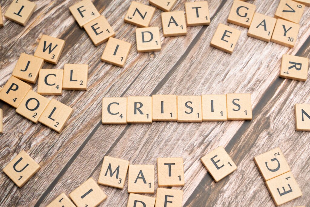 The word crisis spelled with scrabble letters.