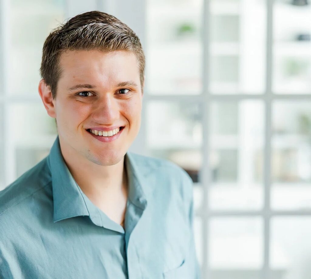A warm, smiling professional headshot of Justin Perry, a licensed marriage and family therapist (LMFT) providing couples counseling in Katy, TX.
